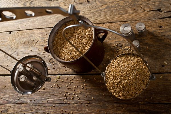 Man Weighs Malt for Home Brewing of Beer. Top View.