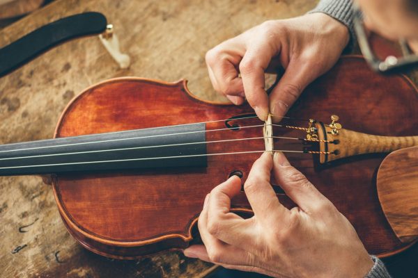 Luthier repair violin in his workshop