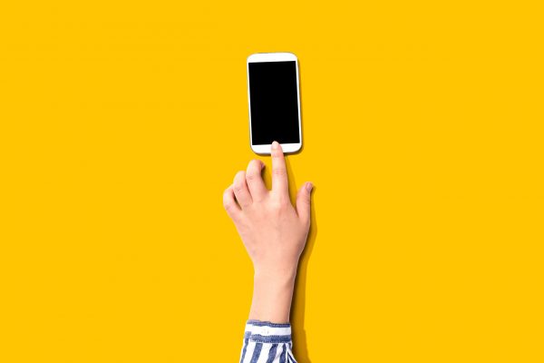 Person using a white smartphone from above