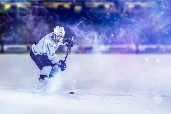 ice hockey player in action kicking with stick